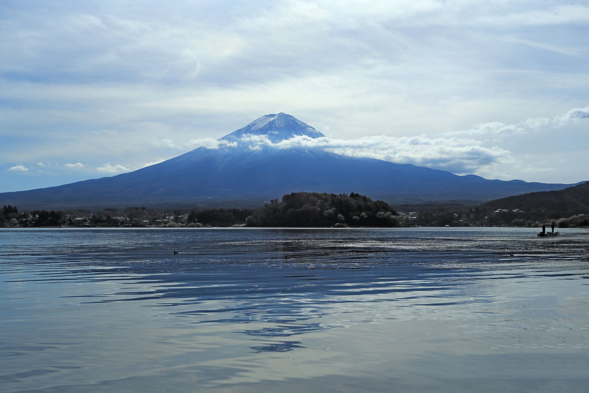 Mt. Fuji rising above the calm water of Lake Kawaguchi