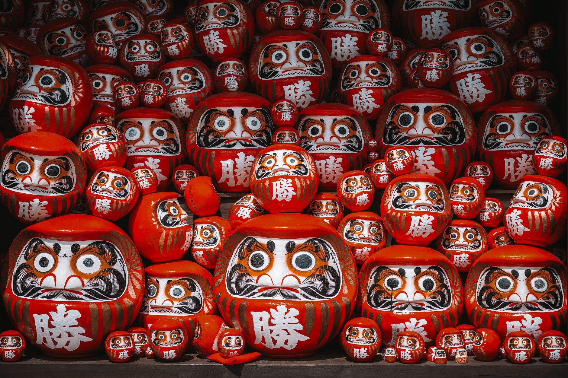 Rows of red victory daruma marked with 勝 at Katsuo-ji temple, Minoh