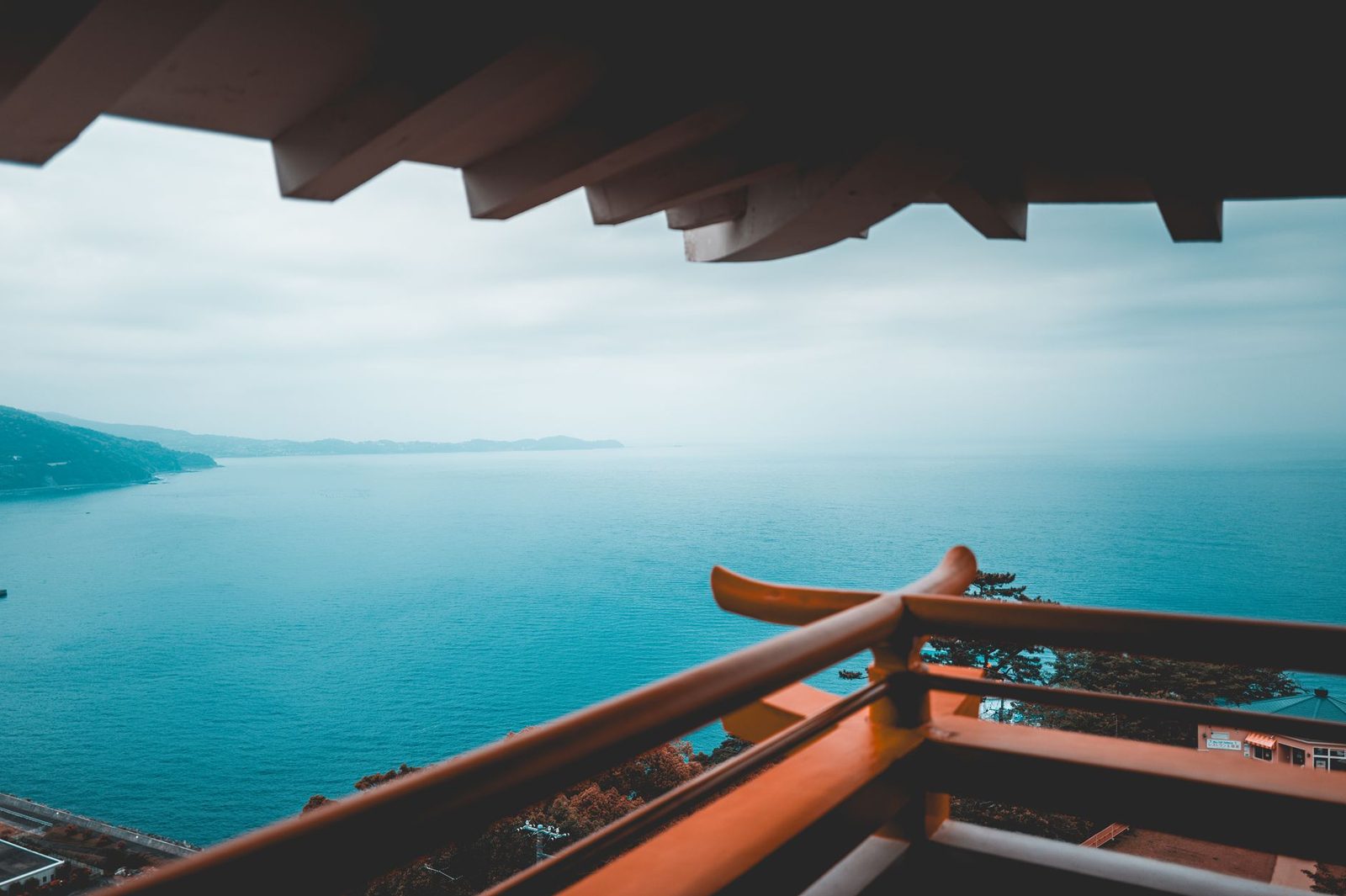 Illustrative photo: View of Atami's coastline from a pagoda, capturing the tranquil blue sea and distant mountains.