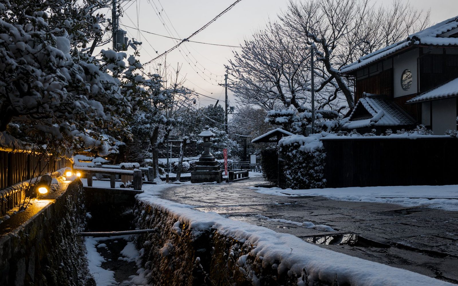 Illustrative photo: Serene winter evening in Kyoto, Japan, with snow-covered traditional architecture.