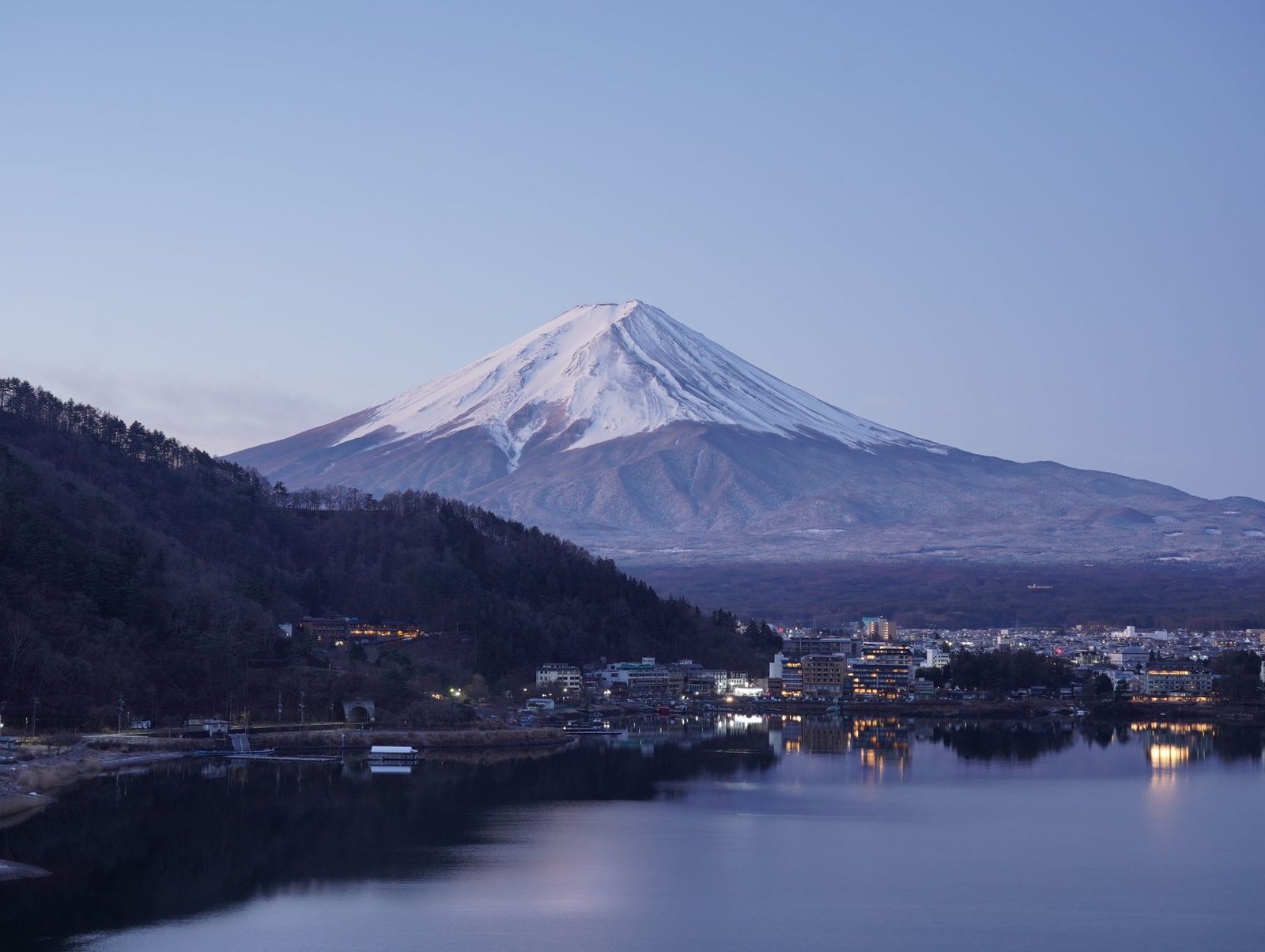 Illustrative photo: Peaceful twilight view of snow-capped Mount Fuji overlooking Kawaguchiko, Japan.