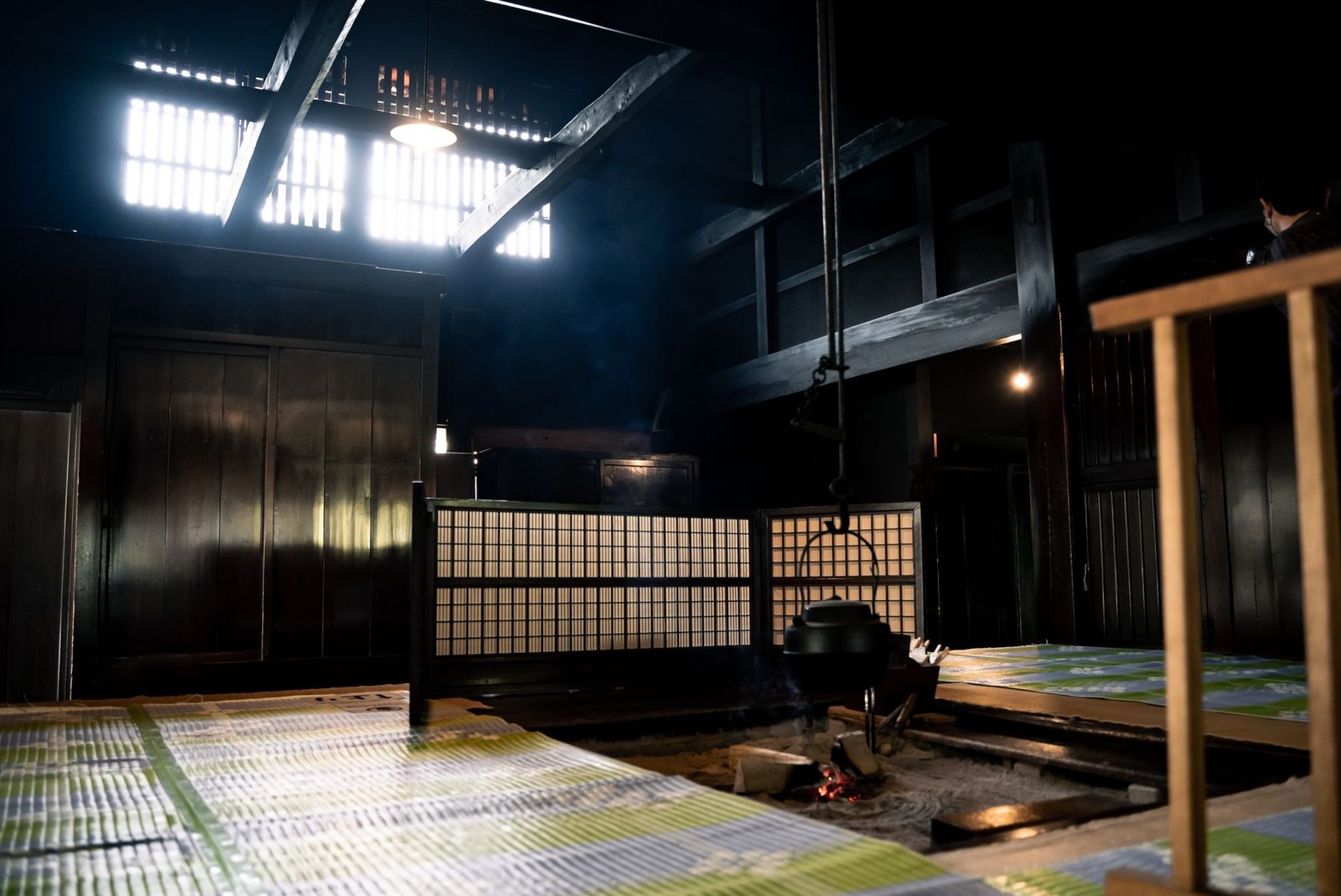 Illustrative photo: A cozy traditional Japanese ryokan interior with a hanging cauldron over an open hearth, reflecting cultural heritage.