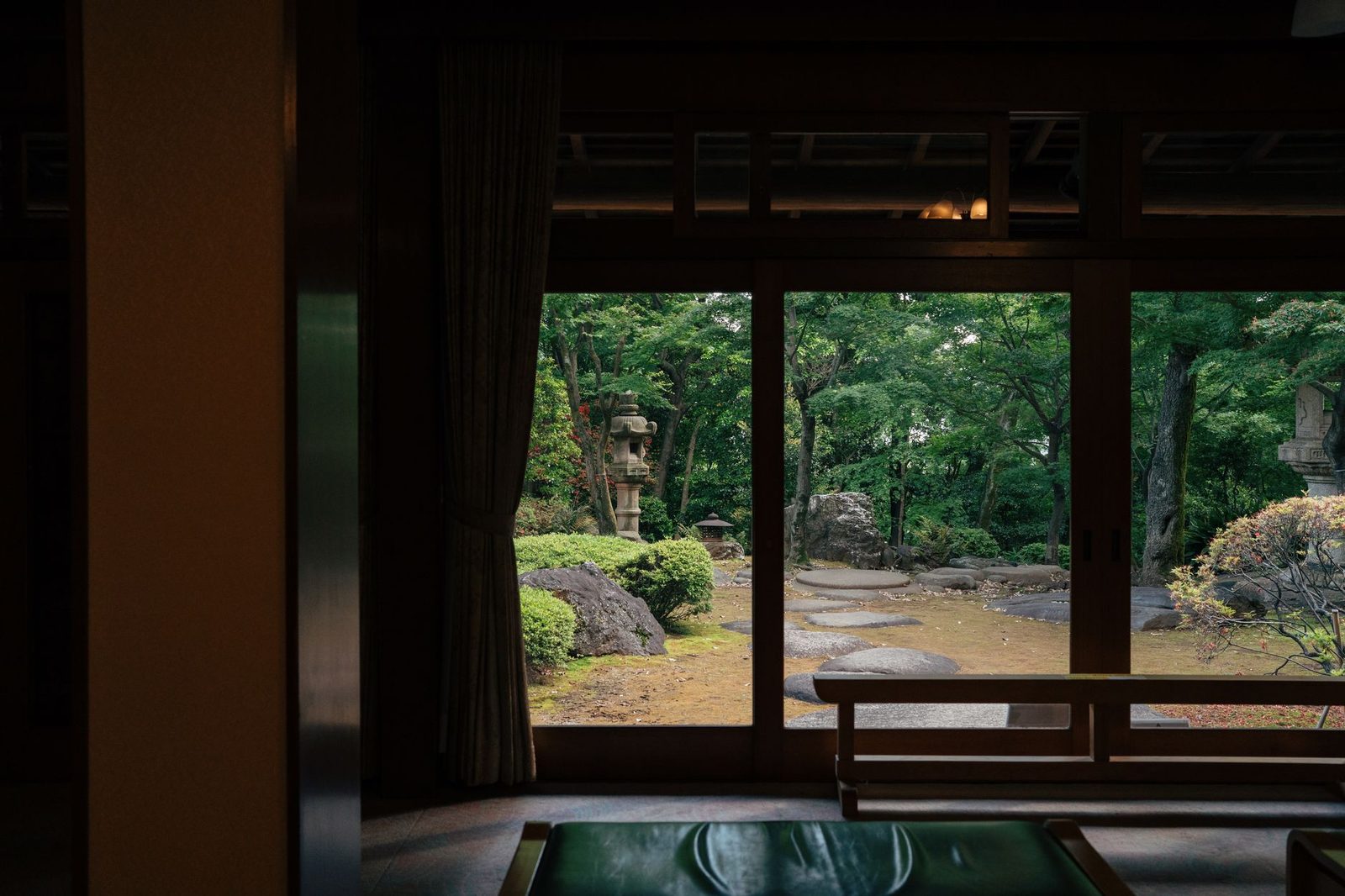 Illustrative photo: Peaceful view of a traditional Japanese garden through a wooden interior in Tokyo, Japan.